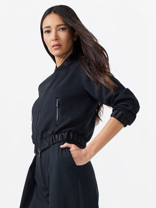 Woman wearing a black outfit on a white background